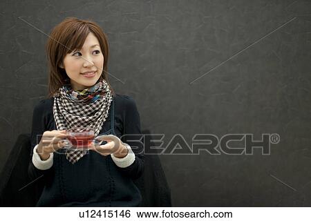 Stock Photograph - Woman drinking tea. Fotosearch