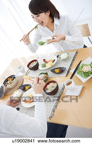 Woman eating a meal (tilted, high angle view) View Large Photo Image Stock Image - Woman eating a meal (tilted, high angle view). Fotosearch
