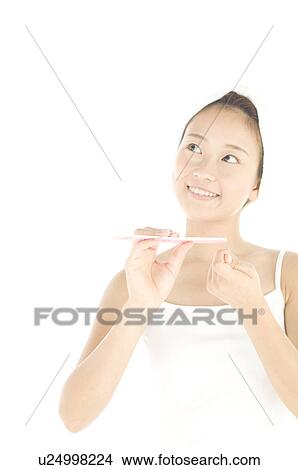 Woman filing her nails View Large Photo Image Picture - Woman filing her nails. Fotosearch