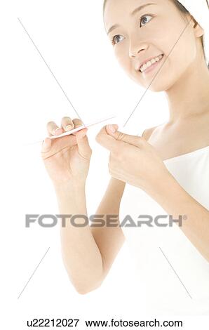 Woman filing her nails View Large Photo Image Stock Photo - Woman filing her nails. Fotosearch