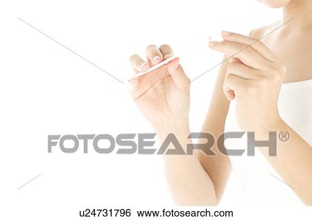 Woman filing her nails View Large Photo Image Stock Photograph - Woman filing her nails. Fotosearch