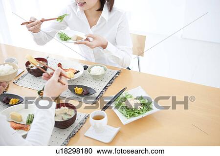 Stock Image - Woman having a meal. Fotosearch