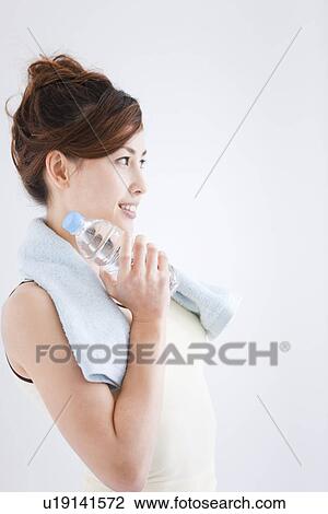 Woman holding bottled water View Large Photo Image Stock Image - Woman holding bottled water. Fotosearch