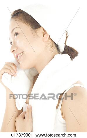 Stock Image - Woman holding towel after bath. Fotosearch