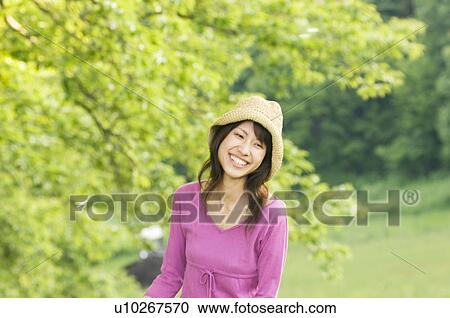 Stock Image - Woman in a park. Fotosearch