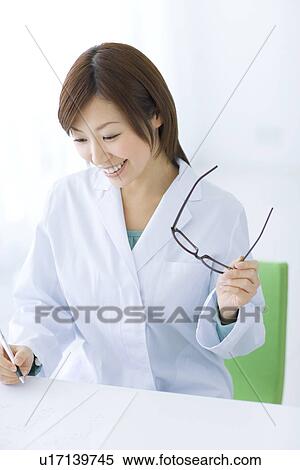 Woman in lab coat doing research View Large Photo Image Stock Photography - Woman in lab coat doing research. Fotosearch