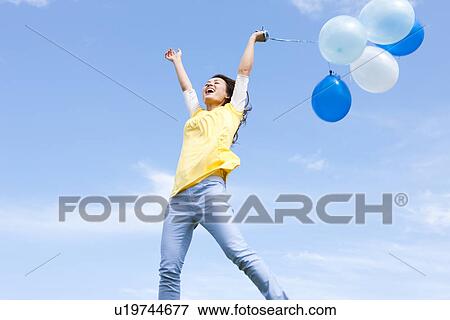 Woman jumping with balloons View Large Photo Image Stock Photo - Woman jumping with balloons. Fotosearch