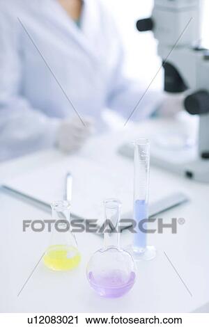 Woman looking through microscope View Large Photo Image Stock Image - Woman looking through microscope. Fotosearch