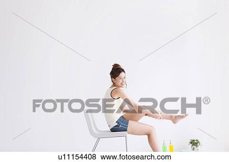 Woman pampering her feet View Large Photo Image Stock Photo - Woman pampering her feet. Fotosearch