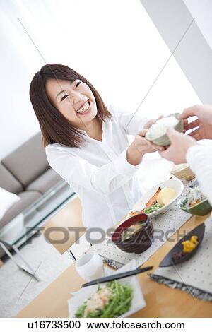 Stock Image - Woman passing teacup. Fotosearch