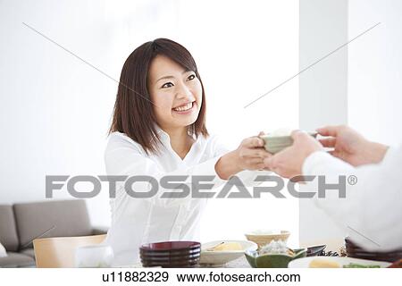 Woman passing teacup View Large Photo Image Stock Photo - Woman passing teacup. Fotosearch