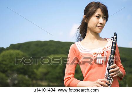 Picture - Woman playing a clarinet. Fotosearch