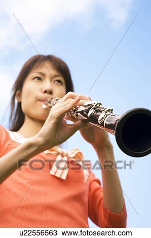 Stock Image - Woman playing a clarinet. Fotosearch