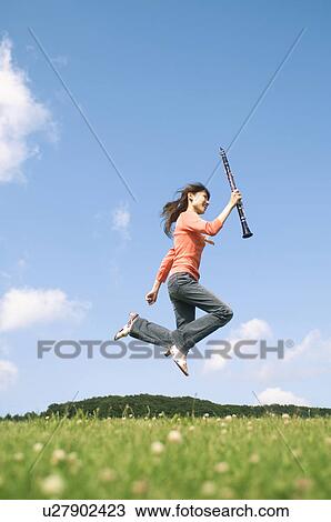 Stock Image - Woman playing a clarinet. Fotosearch
