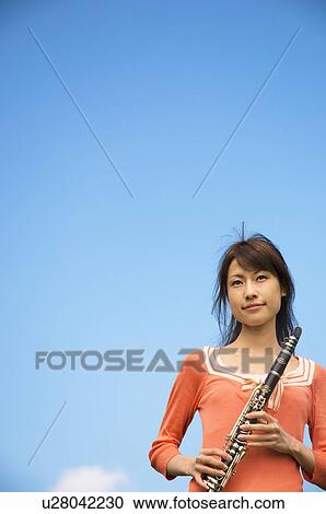 Stock Image - Woman playing a clarinet. Fotosearch