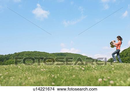 Woman playing a French horn View Large Photo Image Picture - Woman playing a French horn. Fotosearch