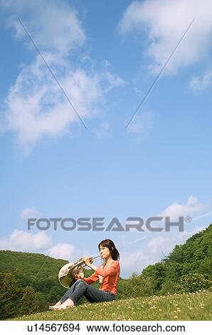 Picture - Woman playing a French horn. Fotosearch