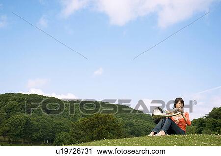 Stock Image - Woman playing a French horn. Fotosearch