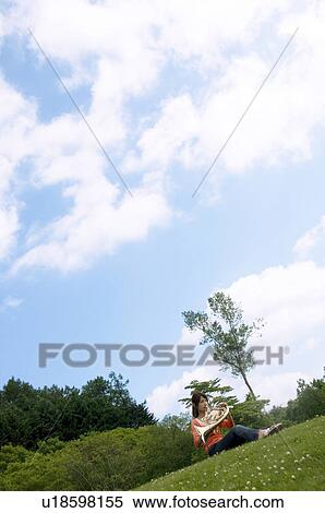 Stock Photography - Woman playing a French horn. Fotosearch