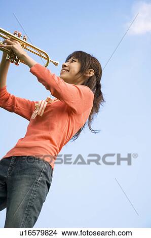 Woman playing a trumpet View Large Photo Image Picture - Woman playing a trumpet. Fotosearch
