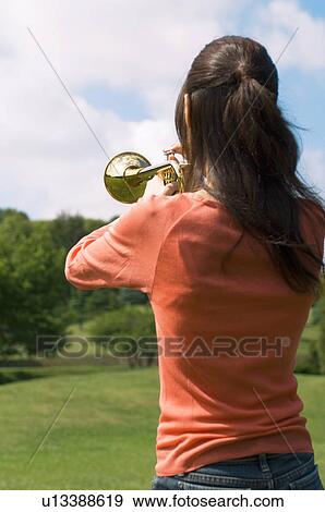 Woman playing a trumpet View Large Photo Image Stock Photo - Woman playing a trumpet. Fotosearch
