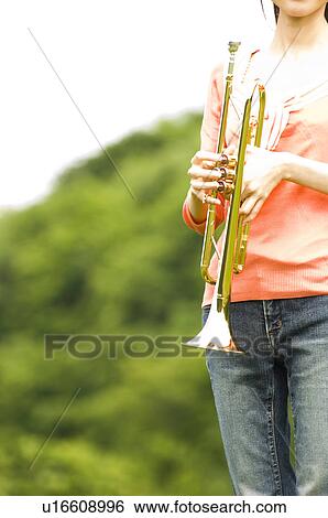Stock Photograph - Woman playing a trumpet. Fotosearch