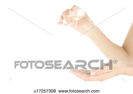 Woman pouring oil into palm View Large Photo Image Stock Photo - Woman pouring oil into palm. Fotosearch