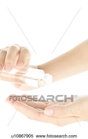 Stock Photography - Woman pouring oil into palm. Fotosearch