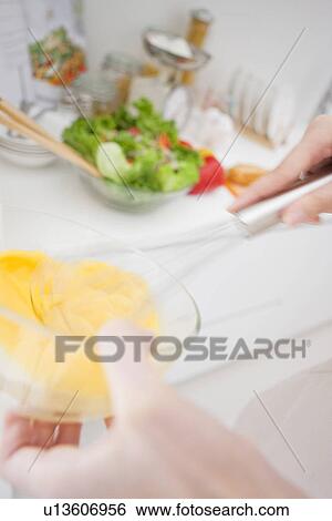 Stock Photograph - Woman preparing meal. Fotosearch
