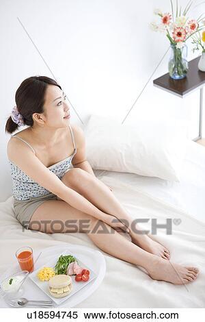 Woman relaxing in bed with breakfast View Large Photo Image Stock Photography - Woman relaxing in bed with breakfast. Fotosearch