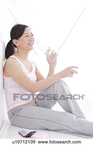 Stock Photo - Woman resting after a workout. Fotosearch