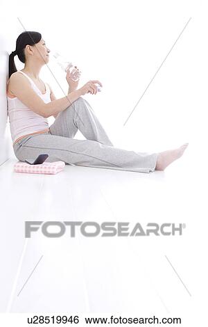 Stock Photograph - Woman resting after a workout. Fotosearch