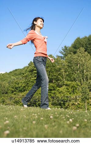 Stock Photography - Woman running in a field. Fotosearch