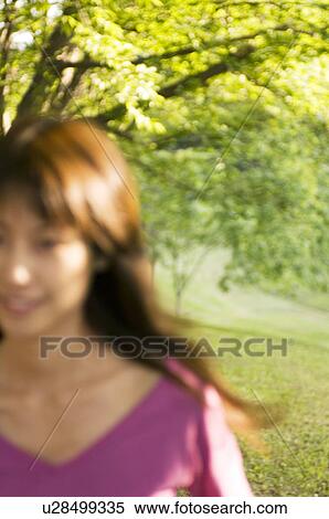 Stock Photography - Woman running through a field. Fotosearch