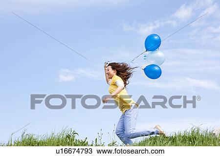 Woman running with balloons View Large Photo Image Stock Image - Woman running with balloons. Fotosearch