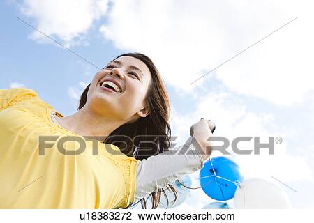 Woman running with balloons View Large Photo Image Stock Image - Woman running with balloons. Fotosearch