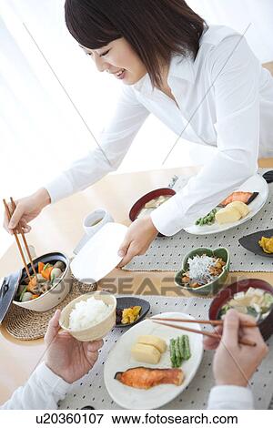 Woman serving food View Large Photo Image Stock Photo - Woman serving food. Fotosearch