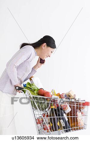 Woman shopping for groceries View Large Photo Image Picture - Woman shopping for groceries. Fotosearch