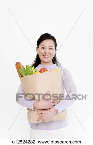 Stock Image - Woman shopping for groceries. Fotosearch
