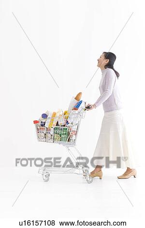 Stock Photo - Woman shopping for groceries. Fotosearch