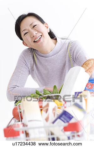 Stock Photo - Woman shopping for groceries. Fotosearch