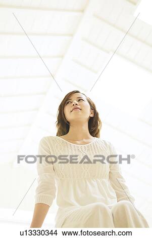 Picture - Woman sitting down. Fotosearch