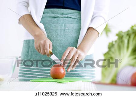 Woman slicing tomatoes View Large Photo Image Stock Photography - Woman slicing tomatoes. Fotosearch