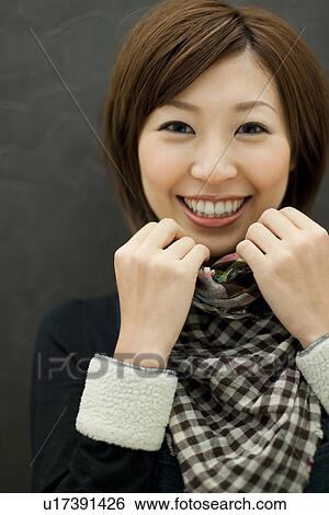 Stock Photograph - Woman smiling at the camera. Fotosearch