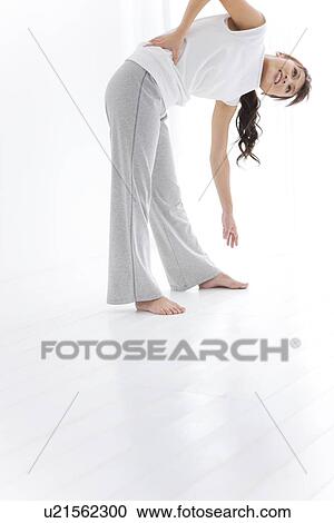 Woman stretching and smiling View Large Photo Image Stock Image - Woman stretching and smiling. Fotosearch
