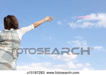 Woman throwing a frisbee View Large Photo Image Stock Image - Woman throwing a frisbee. Fotosearch