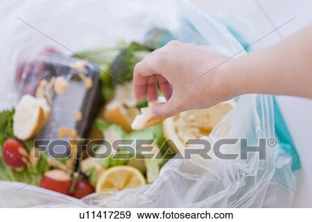 Woman throwing garbage in bin View Large Photo Image Stock Photo - Woman throwing garbage in bin. Fotosearch