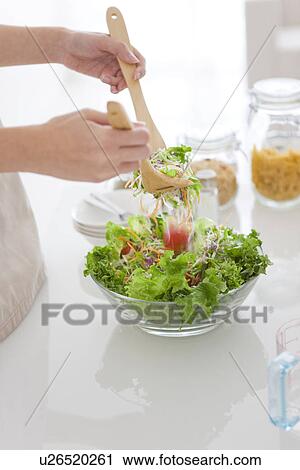 Stock Image - Woman tossing salad. Fotosearch