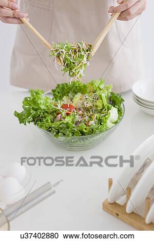 Woman tossing salad View Large Photo Image Stock Image - Woman tossing salad. Fotosearch
