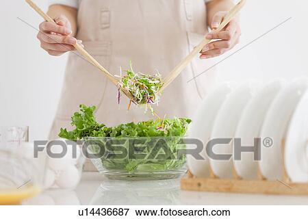 Stock Photo - Woman tossing salad. Fotosearch